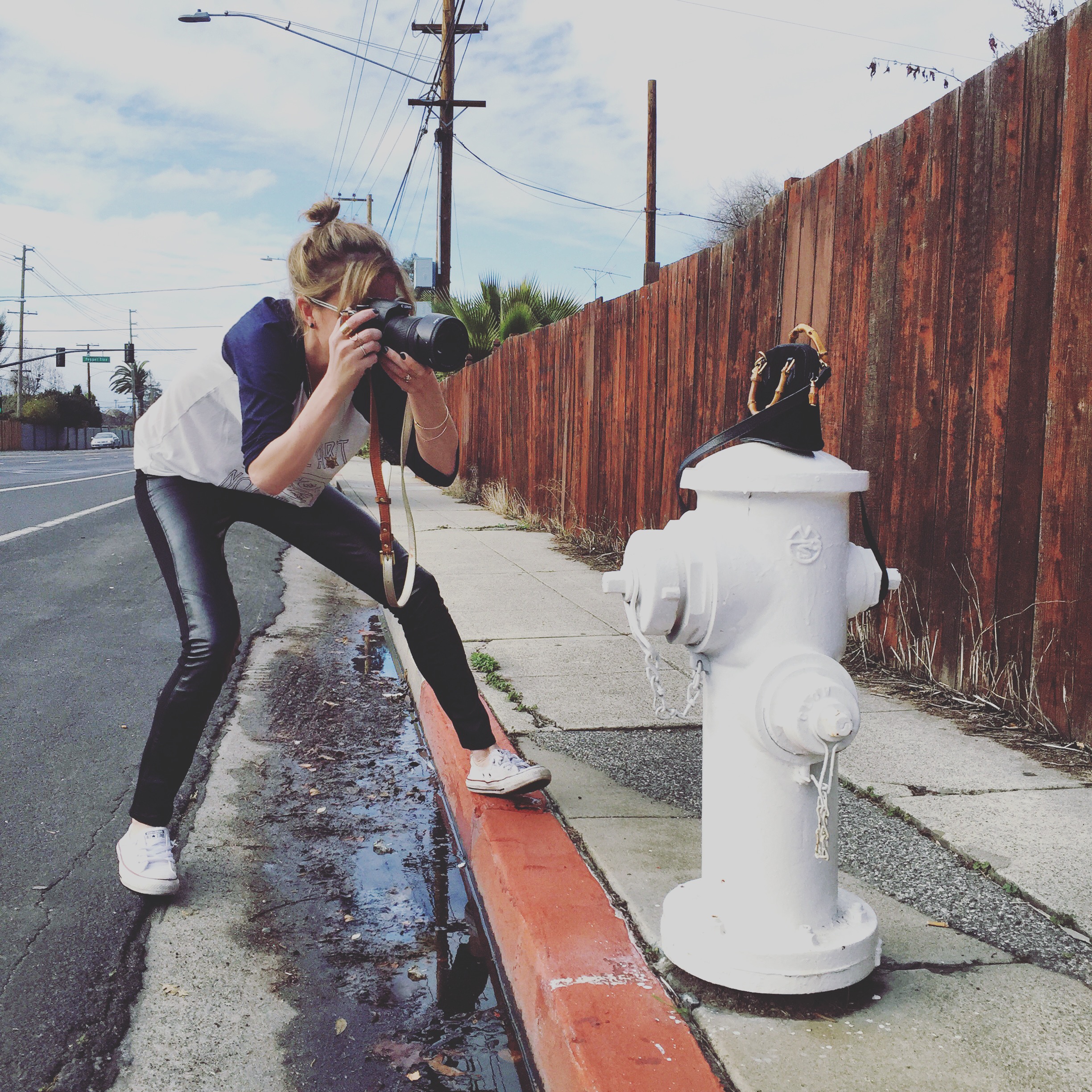 Blogger photographing a purse in the street