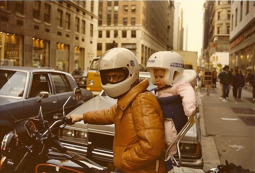 Baby on the back of a motorcycle