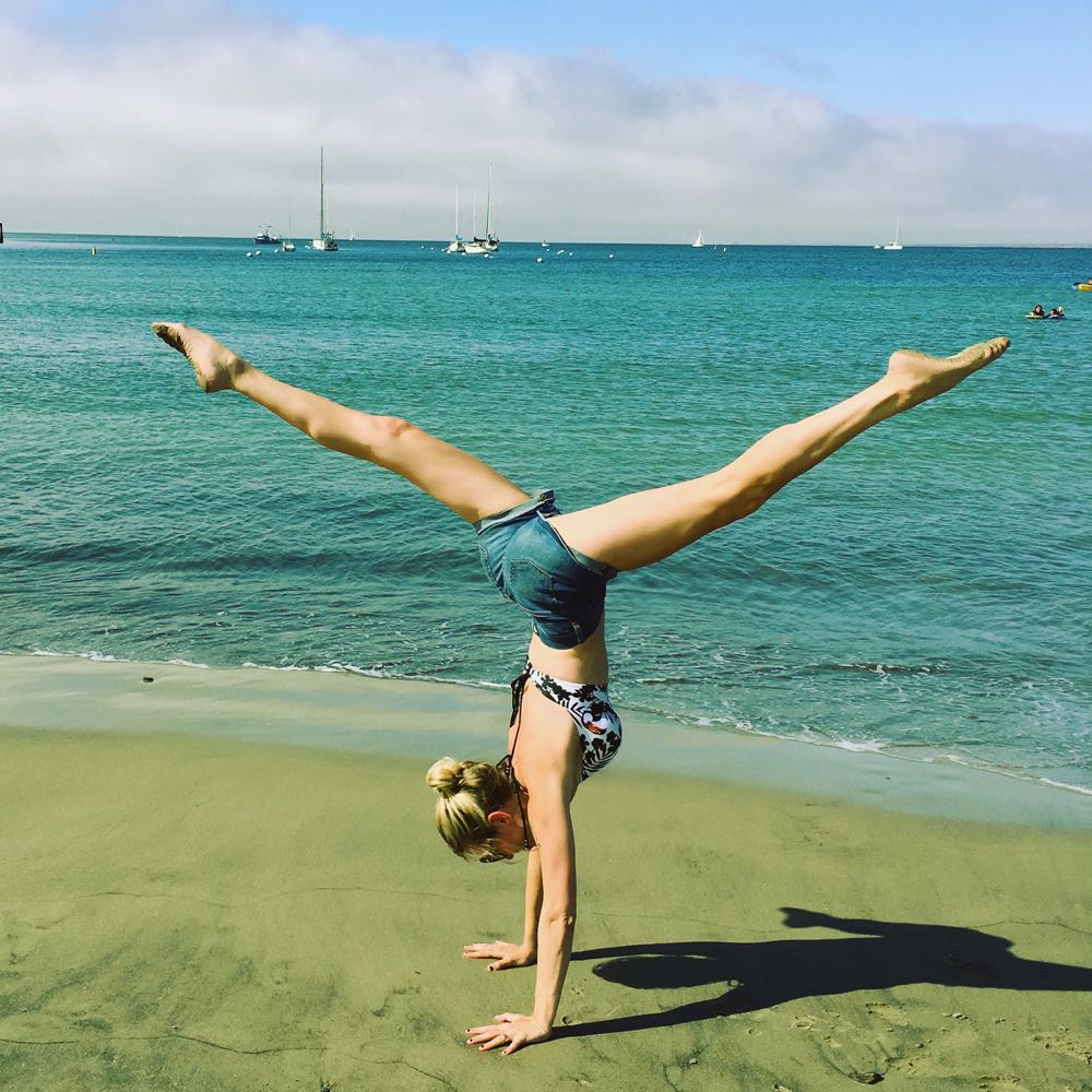 Split handstand on the beach